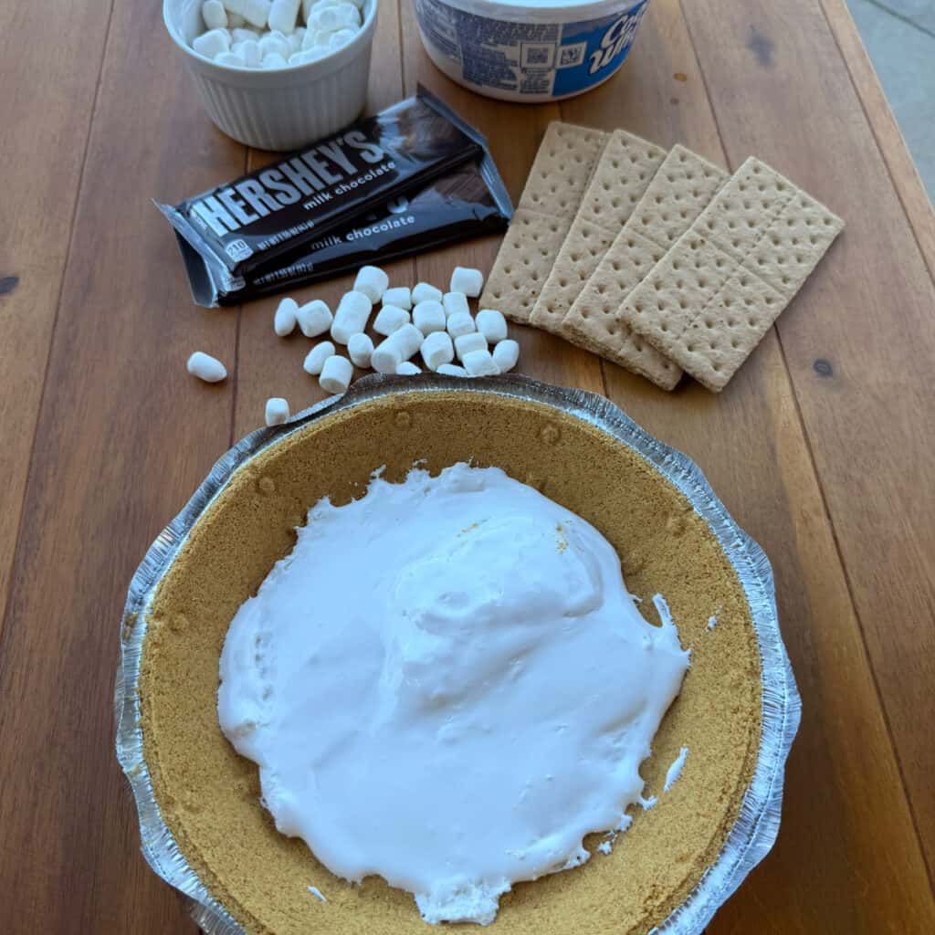 Marshmallow Fluff in bottom of graham cracker crust