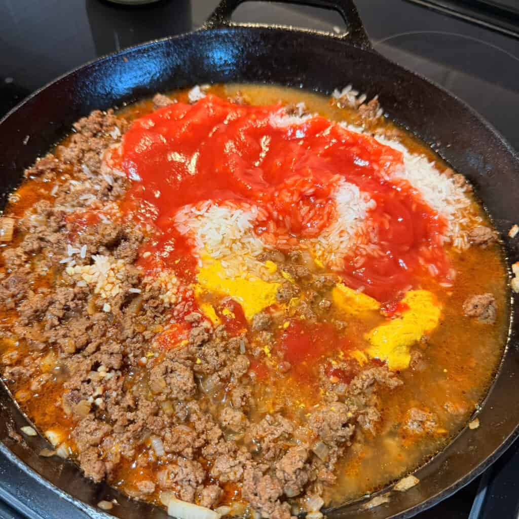 Skillet of ground beef, rice, tomato sauce, mustard