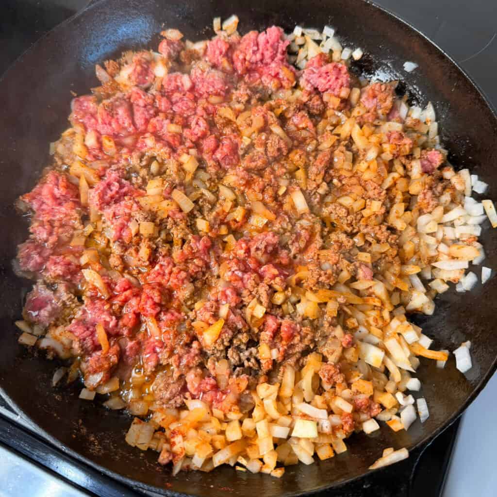 Skillet of ground beef, onions, and seasonings cooking