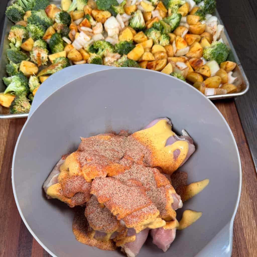 Chicken thighs seasoned and sauced with honey mustard in a bowl
