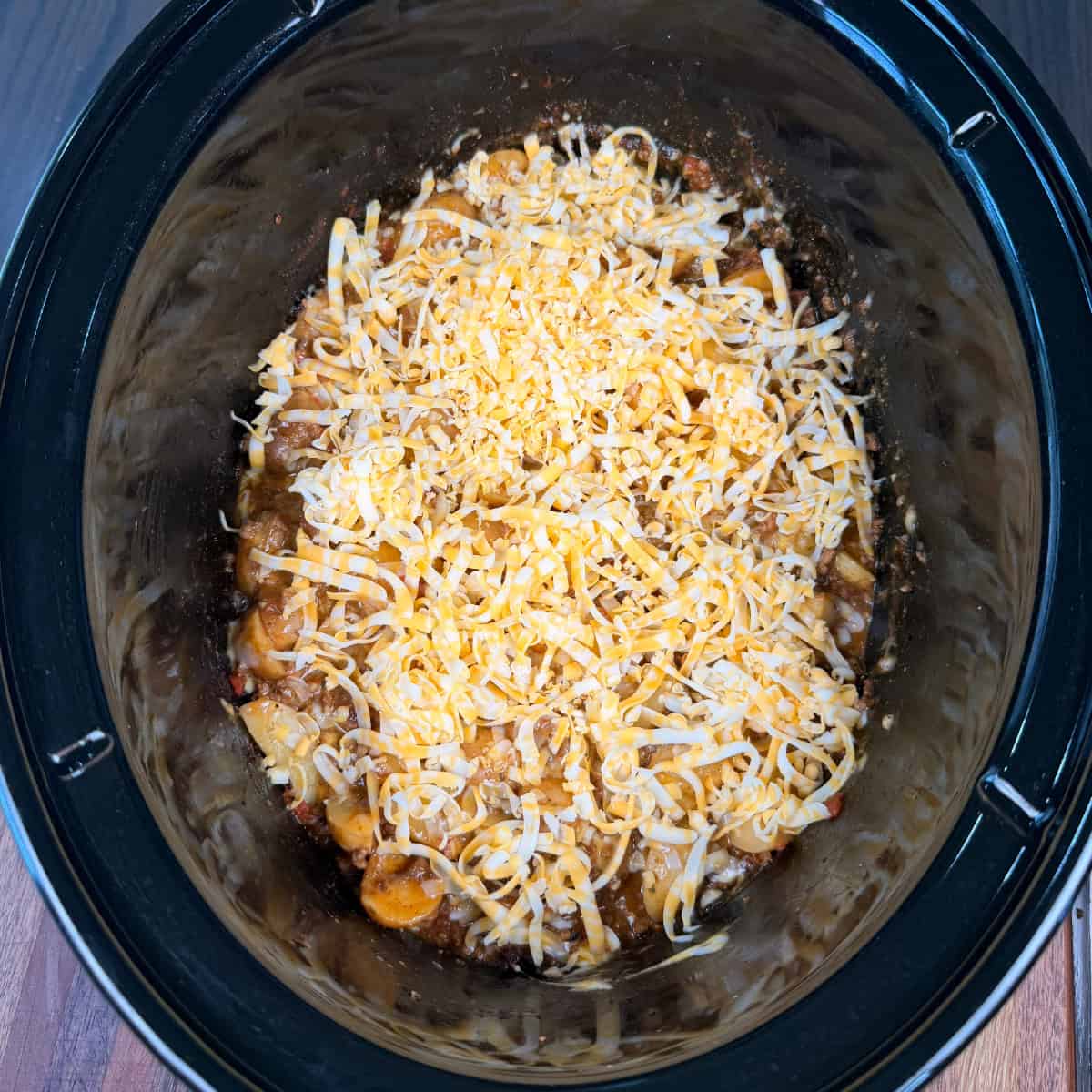 Crockpot Taco Potatoes topped with shredded cheese