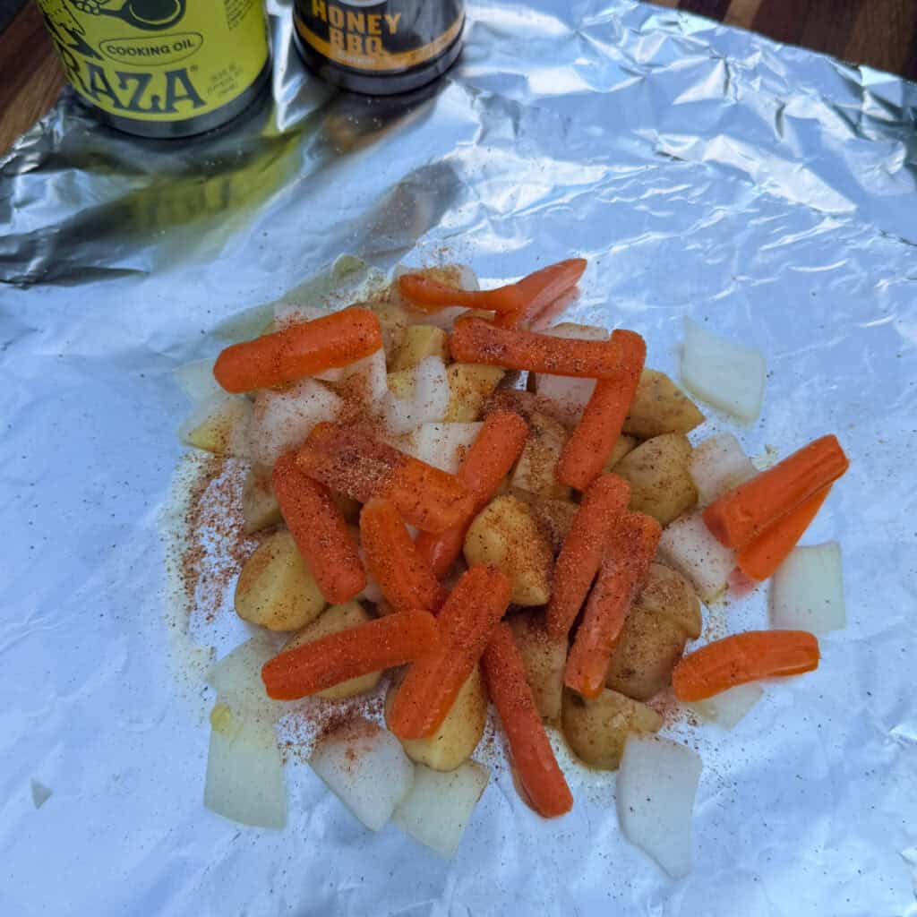 Seasoned potatoes, carrots, onions in foil