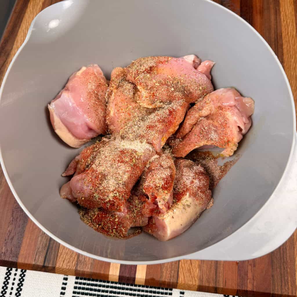 Seasoned chicken thighs in a bowl
