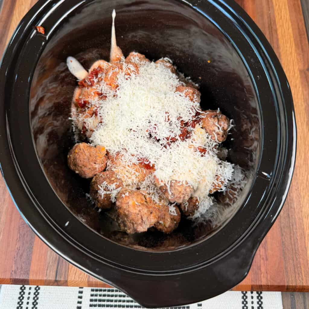 Frozen meatballs in crockpot with seasonings, Alfredo sauce, Parmesan cheese