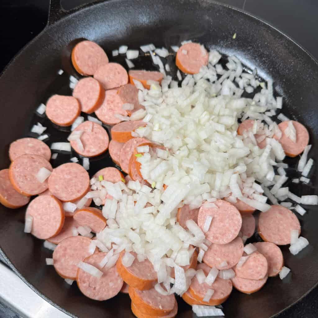 Skillet with onions and sliced kielbasa