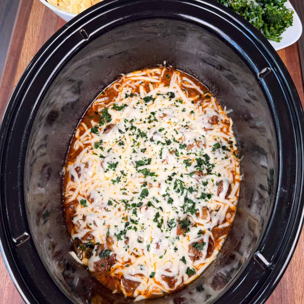 Crockpot French Onion Meatballs topped with cheese and parsley