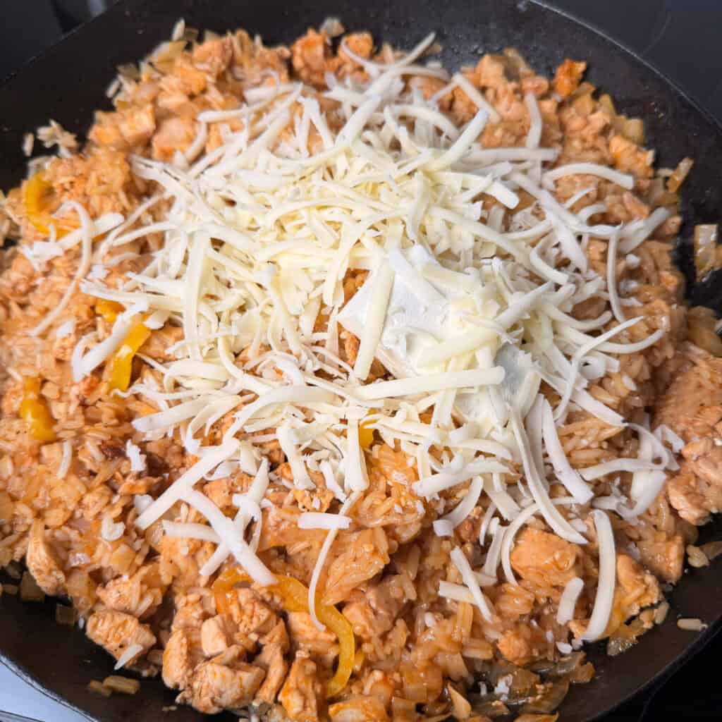 Chicken, rice, cream cheese, mozzarella cheese in skillet