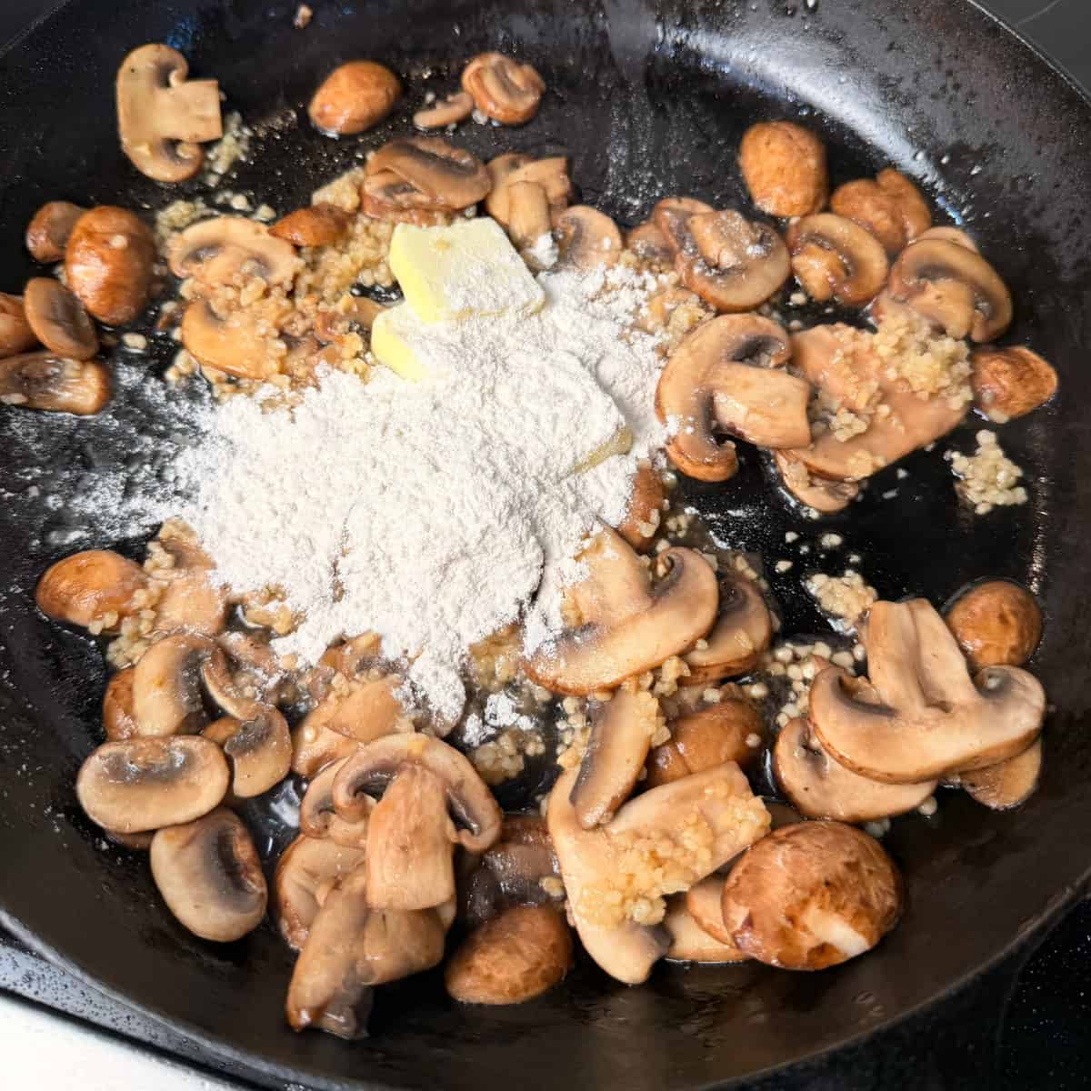 Cooked mushrooms, butter, and flour in cast iron skillet