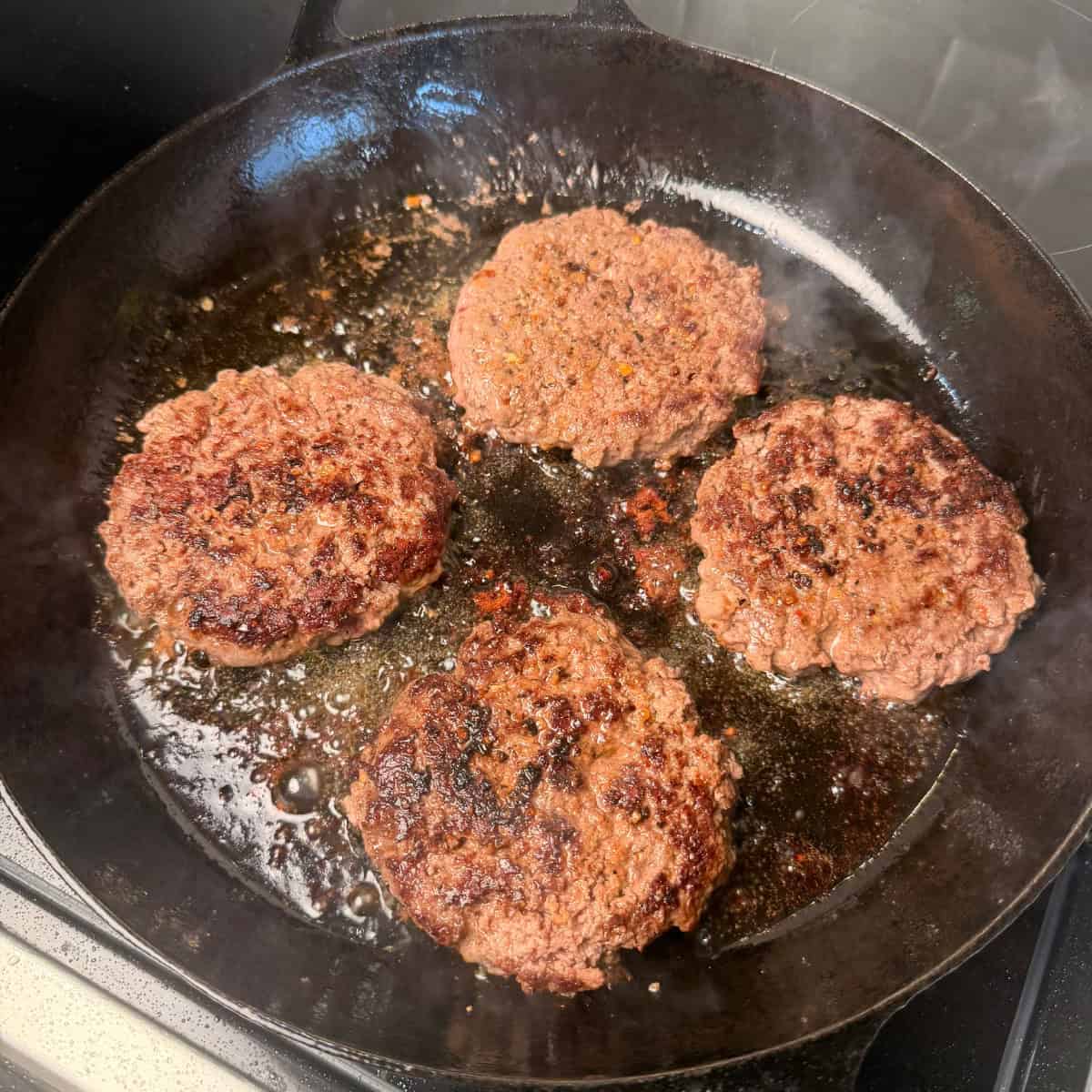 Cooked Burger Patties in cast iron skillet