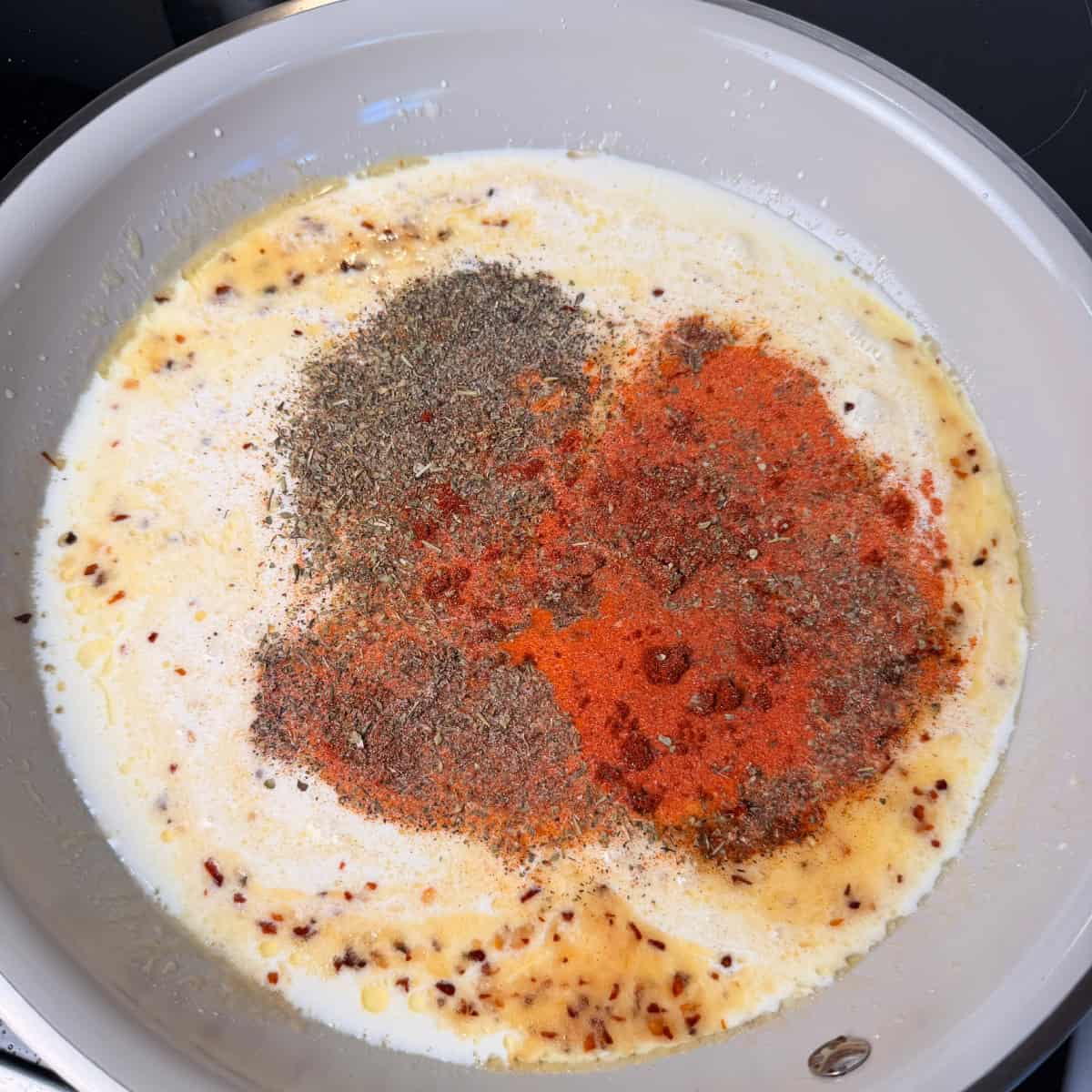 Heavy cream, milk, seasonings in a skillet
